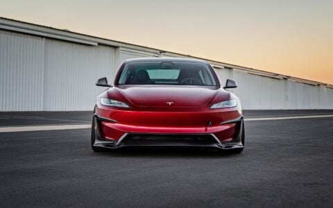2024+ Tesla Model 3 Performance with Carbon Fiber Front Aero Kit parked in a industrial setting.