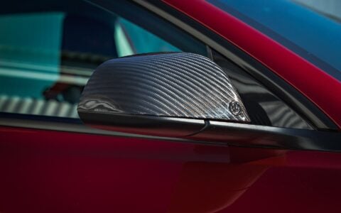 2024+ Tesla Model 3 Performance - Carbon Fiber Mirror Cap showing Unplugged Performance badge logo