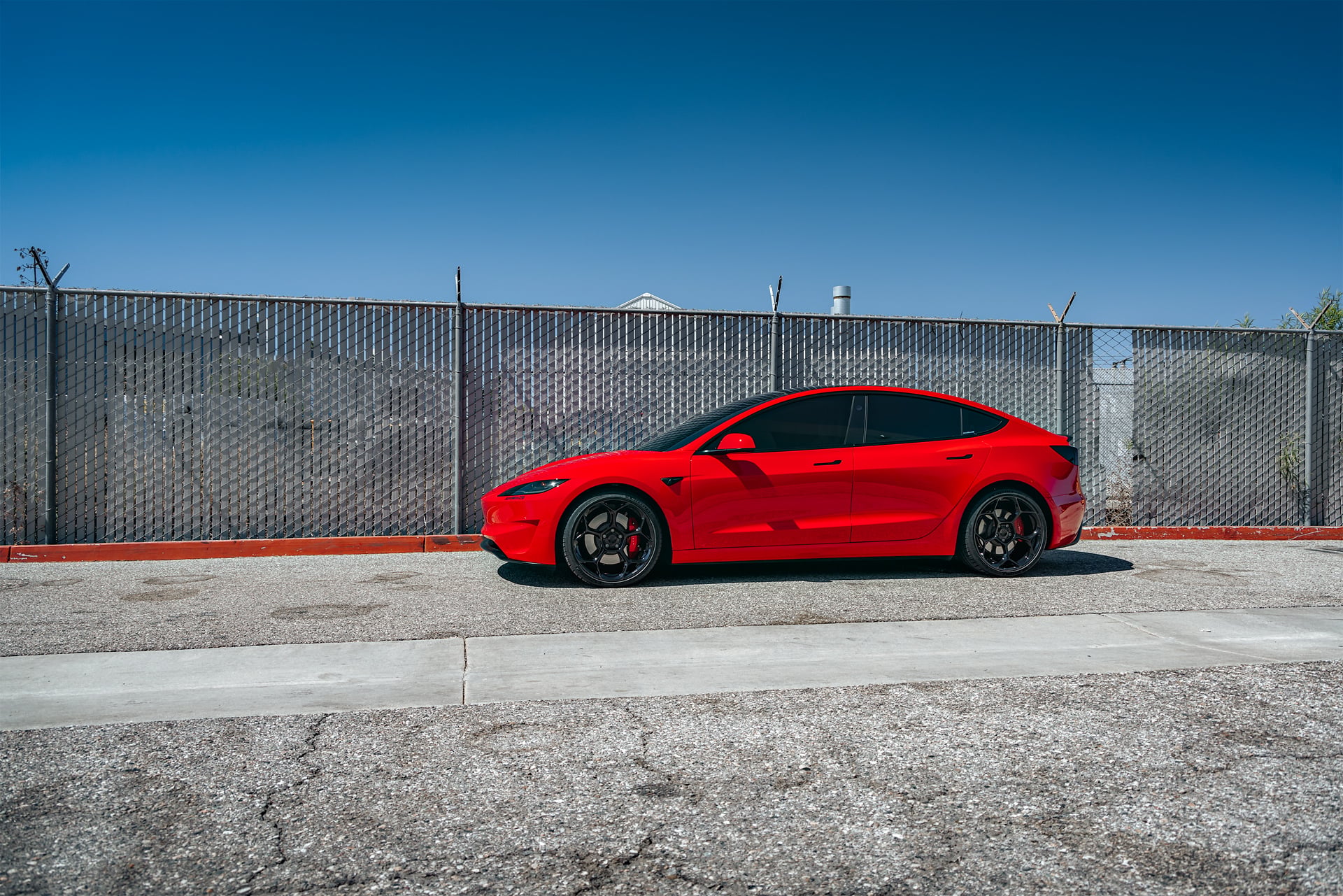 Bright Red 2024 Tesla Model 3 Performance 20 inch UP-05 Wheels in Gloss Black
