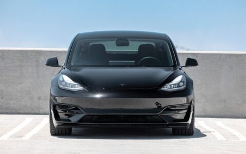 Lowered Black Tesla Model 3 Performance riding on Satin Titanium UP-03 forged wheels, enhanced with Unplugged Performance's dual rate lowering springs.