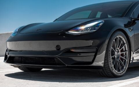 Tesla Model 3 with Ascension R Front Fascia System and UP-03 Forged Wheels in Satin Titanium by Unplugged Performance, featuring Michelin tires and an aggressive, aerodynamic front design for enhanced performance.