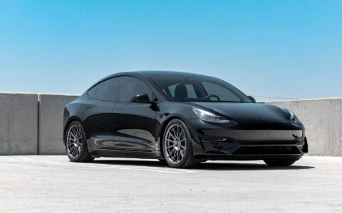 Black Tesla Model 3 equipped with Unplugged Performance Ascension R Front Fascia and 19-inch UP-03 Forged Wheels in Satin Titanium, offering a seamless blend of style, aerodynamics, and performance.