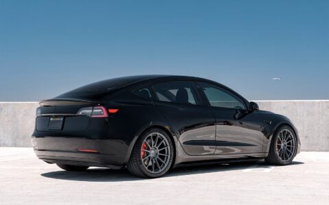 Black Tesla Model 3 featuring Unplugged Performance UP-03 Forged Wheels in Satin Titanium. Forged wheel design enhances both the sleek aesthetic and high-performance capabilities, delivering improved handling and reduced weight.