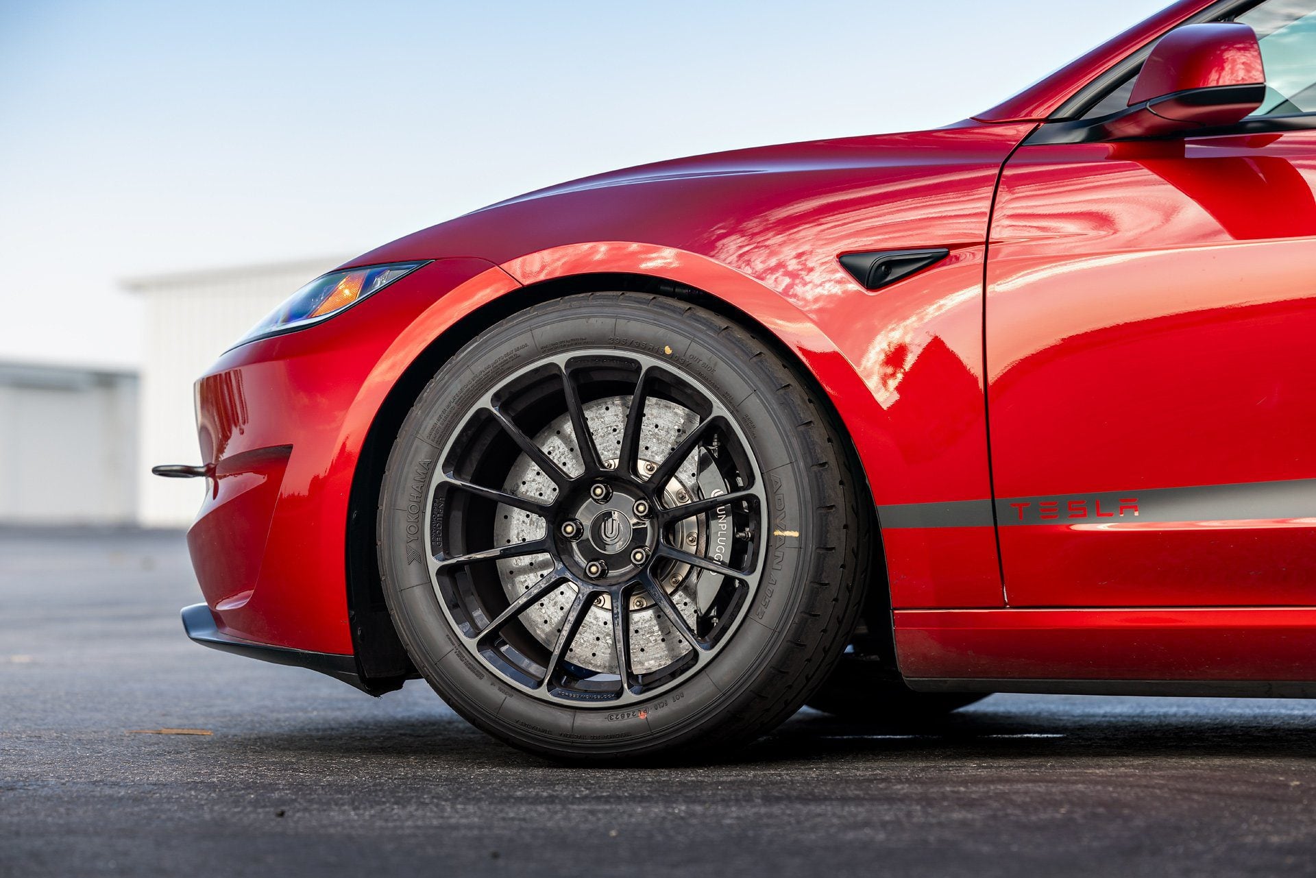 Tesla Model 3 Performance front shot featuring UP-03 Gloss Black Forged Wheels by Unplugged Performance, enhancing both style and function.