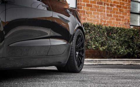 Close-up shot of Tesla Model 3 Performance showcasing UP-03 Forged Wheels in Gloss Black by Unplugged Performance, paired with Michelin Pilot Sport 4S tires.