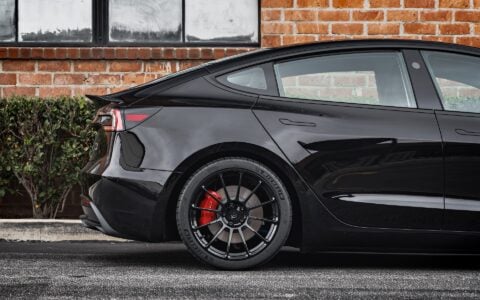 Rear shot of Tesla Model 3 Performance showcasing UP-03 Forged Wheels in Gloss Black by Unplugged Performance, paired with Michelin Pilot Sport 4S tires and red Tesla brake calipers.