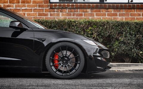 Close-up shot of Tesla Model 3 Performance showcasing UP-03 Forged Wheels in Gloss Black by Unplugged Performance, paired with Michelin Pilot Sport 4S tires and red Tesla brake calipers.