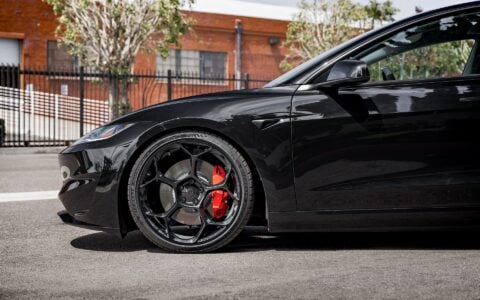 Close-up shot of Tesla Model 3 Performance showcasing UP-05 Forged Wheels in Gloss Black by Unplugged Performance, paired with Michelin Pilot Sport 4S tires and red Tesla brake calipers.