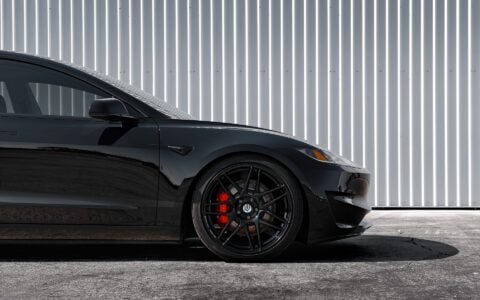 Side profile of a black Tesla Model 3 Performance, featuring Unplugged Performance's UP X BBS Flugplatz Wheels in Gloss Black.