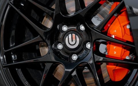 Close-up of UP X BBS Flugplatz Wheels in Gloss Black by Unplugged Performance, emphasizing the precise fitment and premium performance design on a Tesla Model 3 Performance.