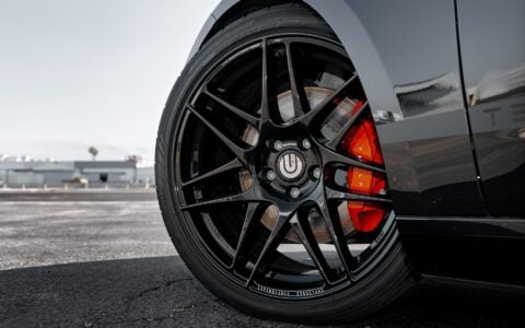 Close-up of UP X BBS Flugplatz Wheels in Gloss Black by Unplugged Performance, emphasizing the precise fitment and premium performance design on a 2024 Tesla Model 3 Performance.